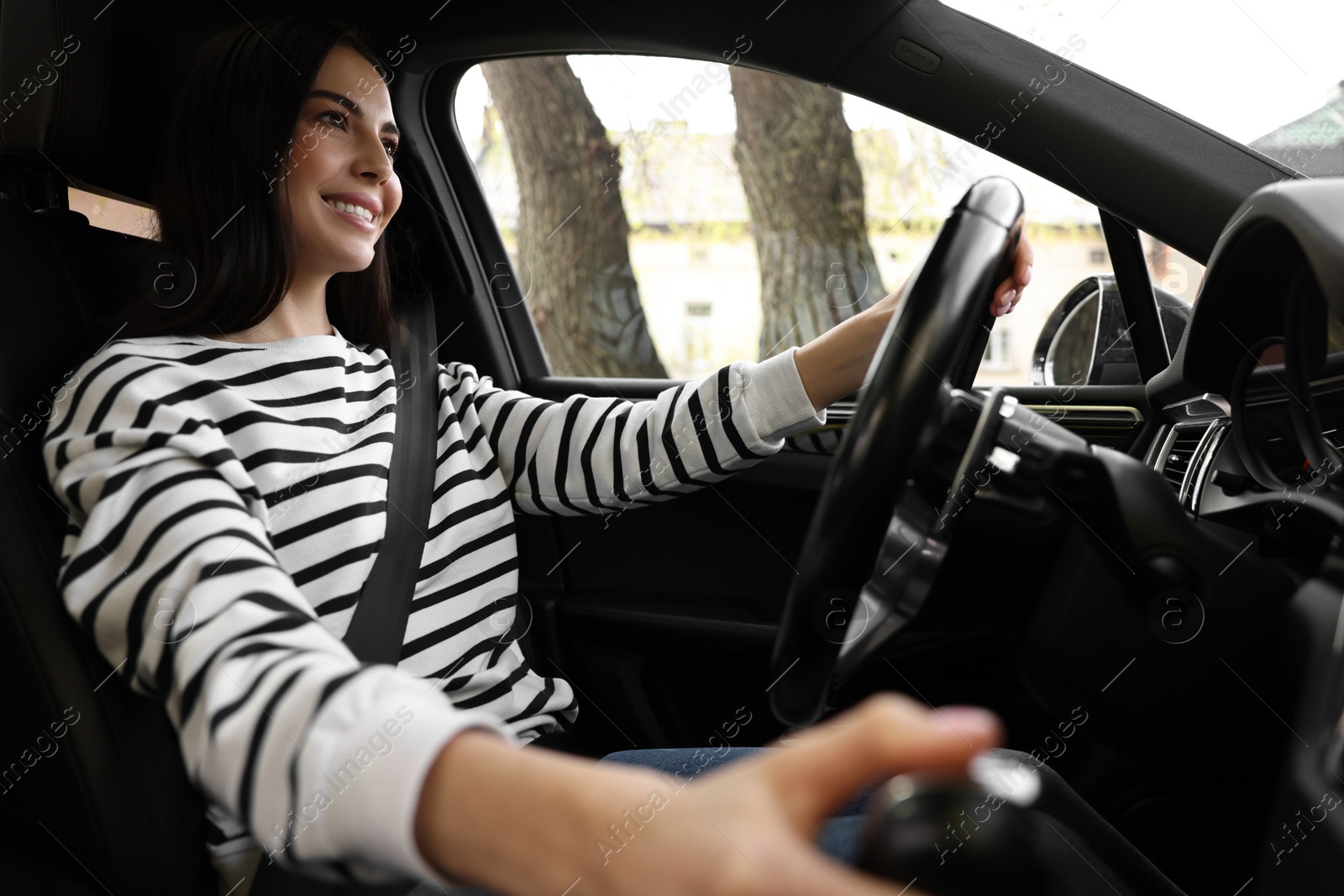 Photo of Woman with safety seat belt driving her modern car