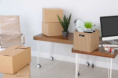 Photo of Interior of modern office with packed belongings. Moving service