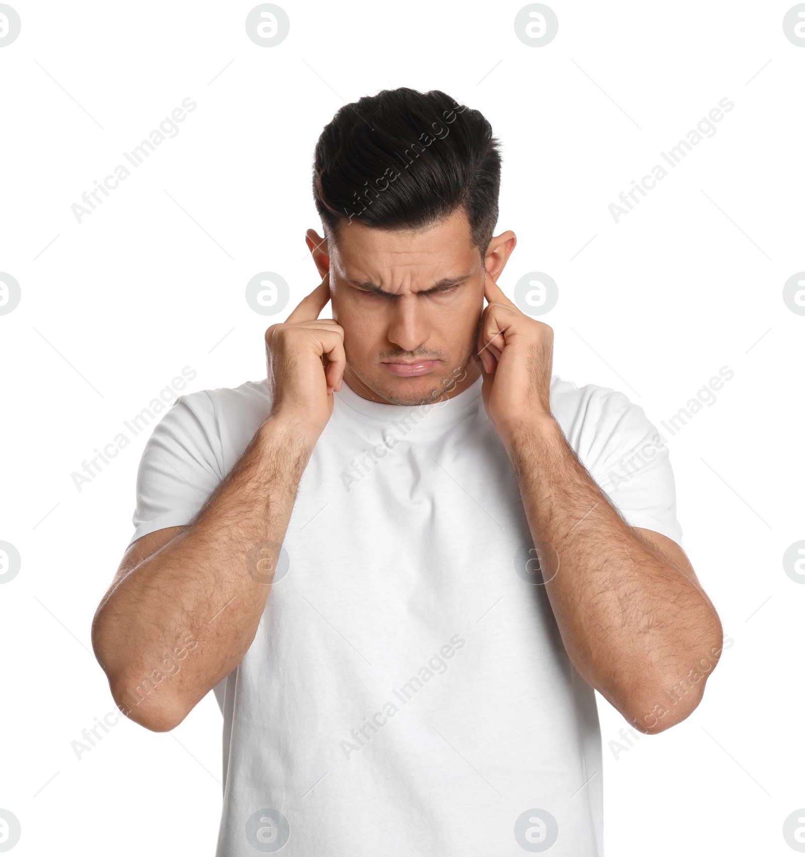 Photo of Emotional man covering ears with fingers on white background