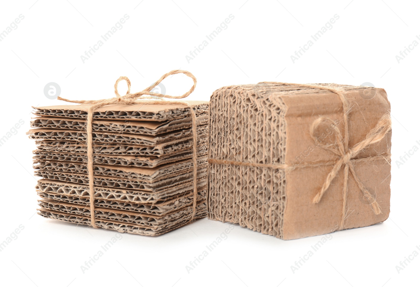 Photo of Stacks of cardboard pieces on white background. Recyclable material