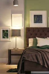 Photo of Modern room interior with comfortable bed and stylish lamp