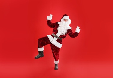 Full length portrait of Santa Claus on red background