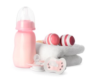 Photo of Bottle with milk, toys, towel and baby pacifier isolated on white