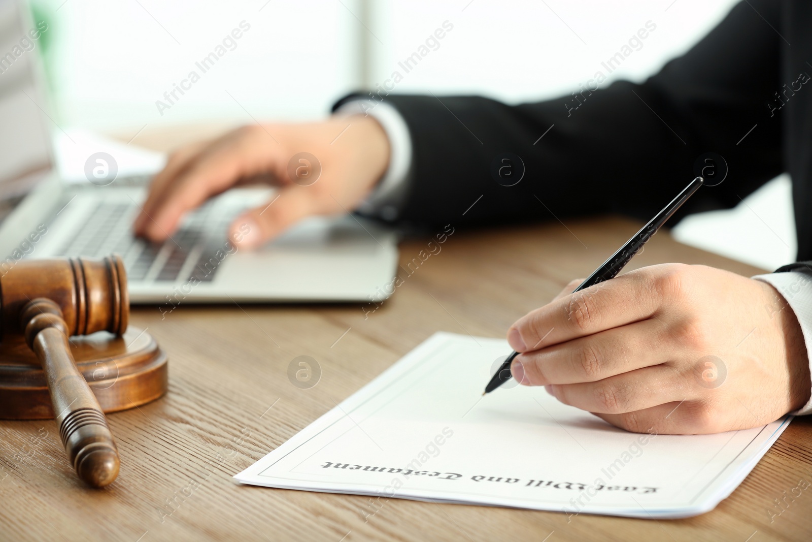 Photo of Male notary working with documents and laptop at table, closeup