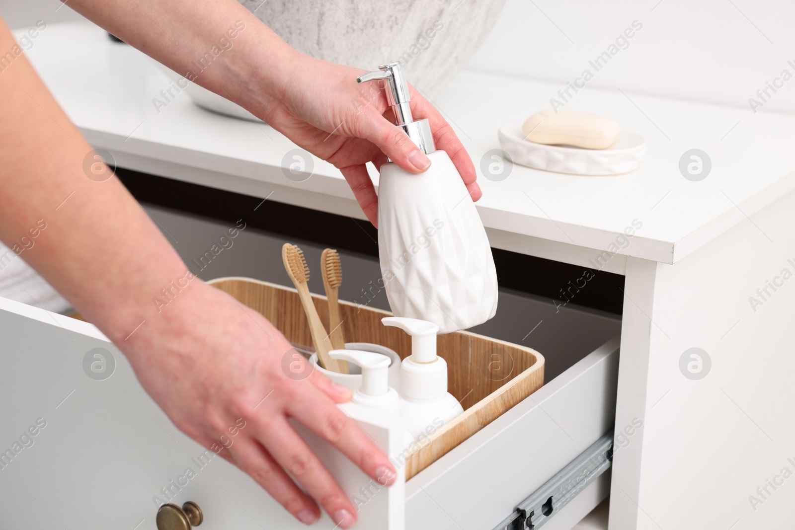 Photo of Bath accessories. Woman with container of cosmetic product indoors, closeup