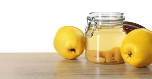 Delicious quince drink and fresh fruits on wooden table against white background