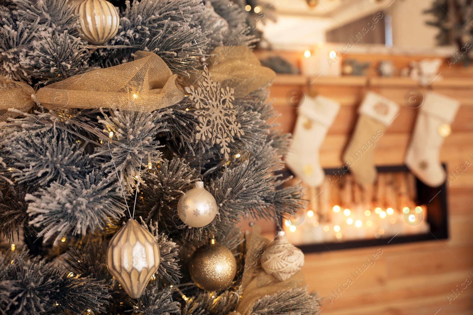 Photo of Beautiful decorated Christmas tree near fireplace. Festive interior