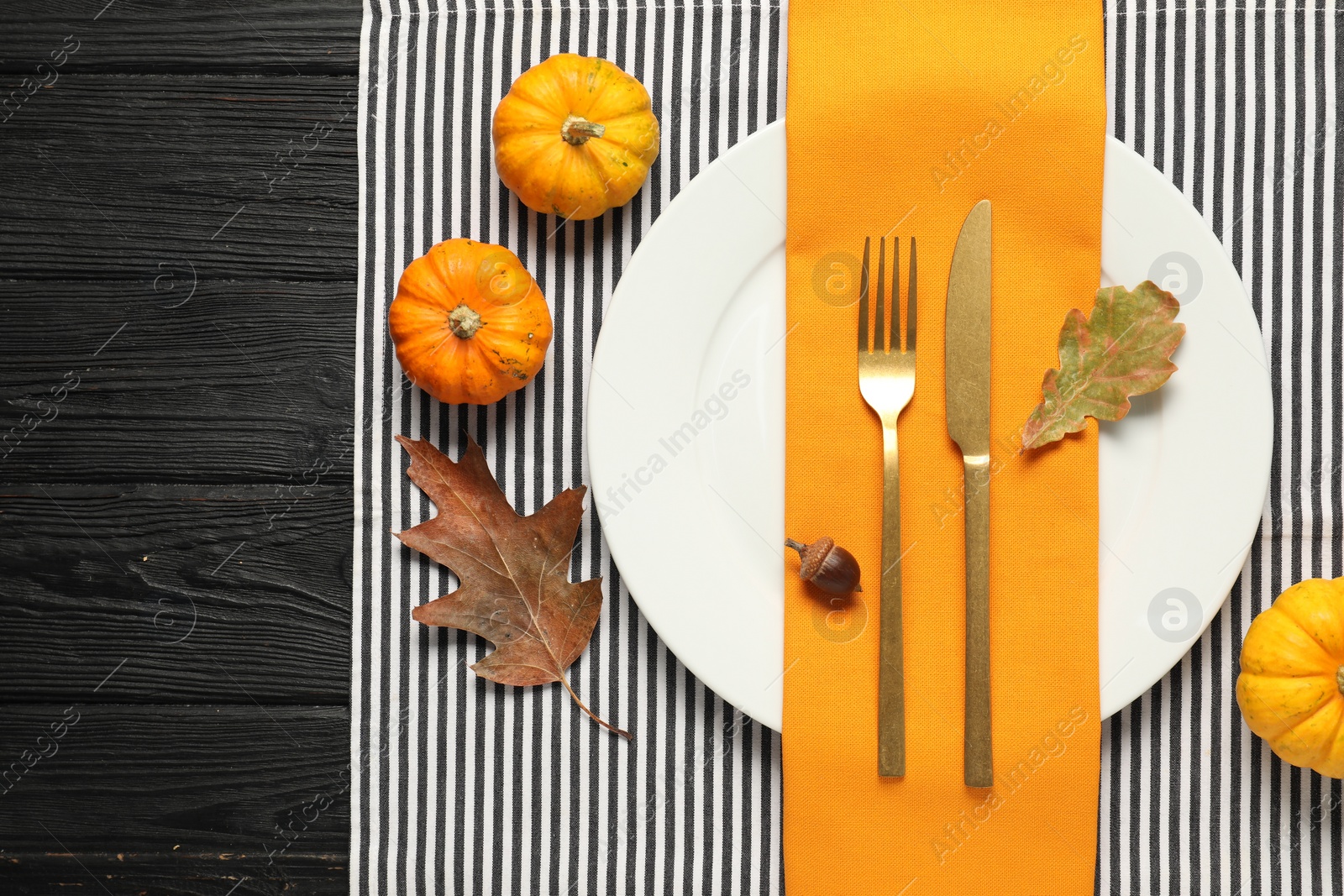 Photo of Autumn table setting, pumpkins and dry leaves, flat lay. Space for text