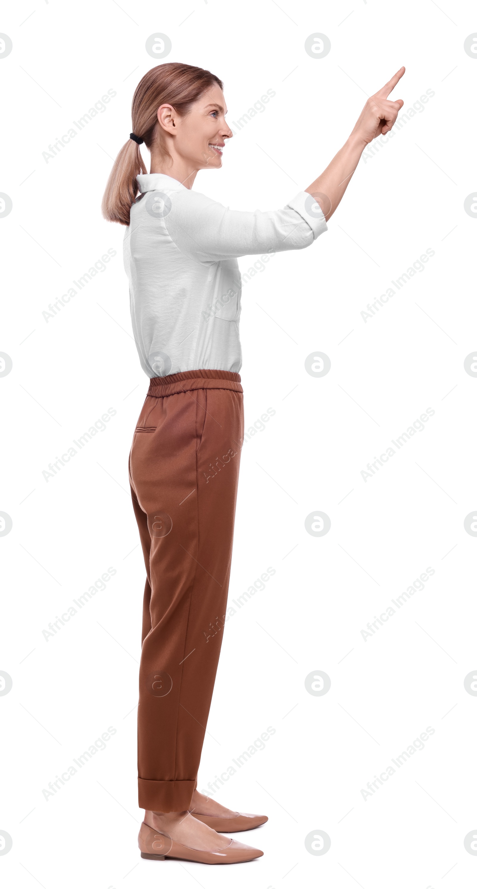 Photo of Beautiful happy businesswoman pointing at something on white background