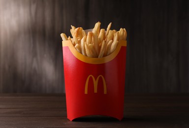 MYKOLAIV, UKRAINE - AUGUST 12, 2021: Big portion of McDonald's French fries on wooden table
