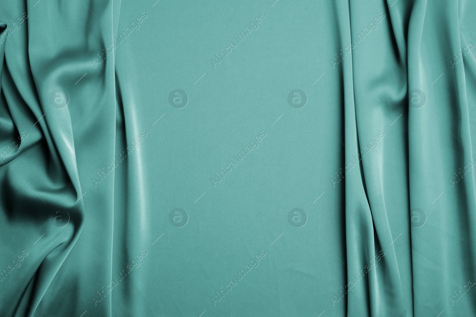 Image of Delicate green silk fabric as background, top view. Space for text