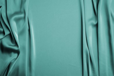 Image of Delicate green silk fabric as background, top view. Space for text