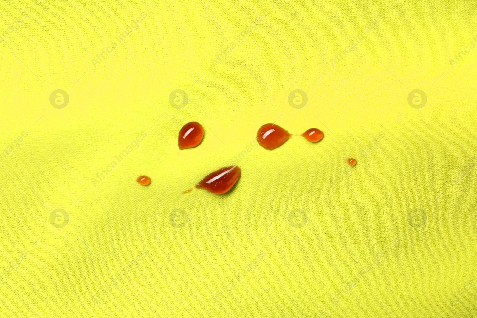 Photo of Stains of jam on green fabric, top view