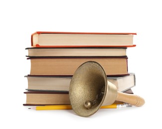 Photo of Golden school bell with wooden handle, pencils and stack of books on white background