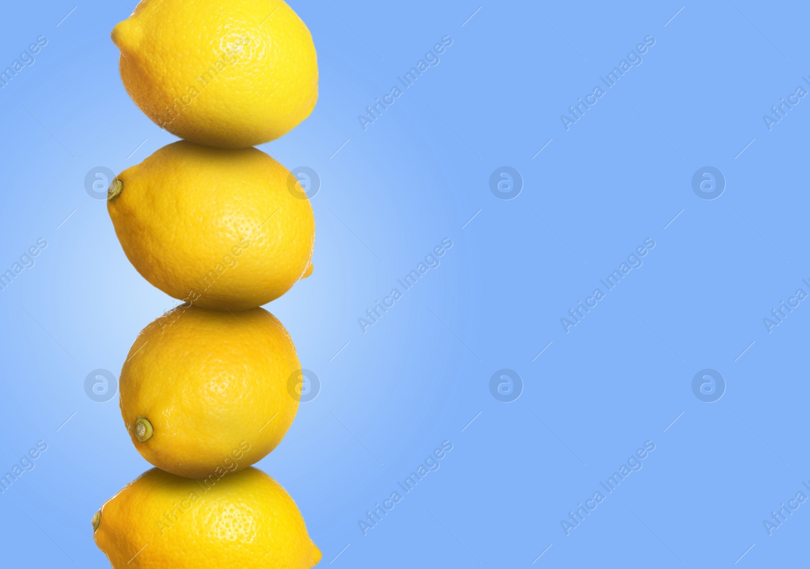 Image of Stack of whole fresh lemons on light blue background, space for text