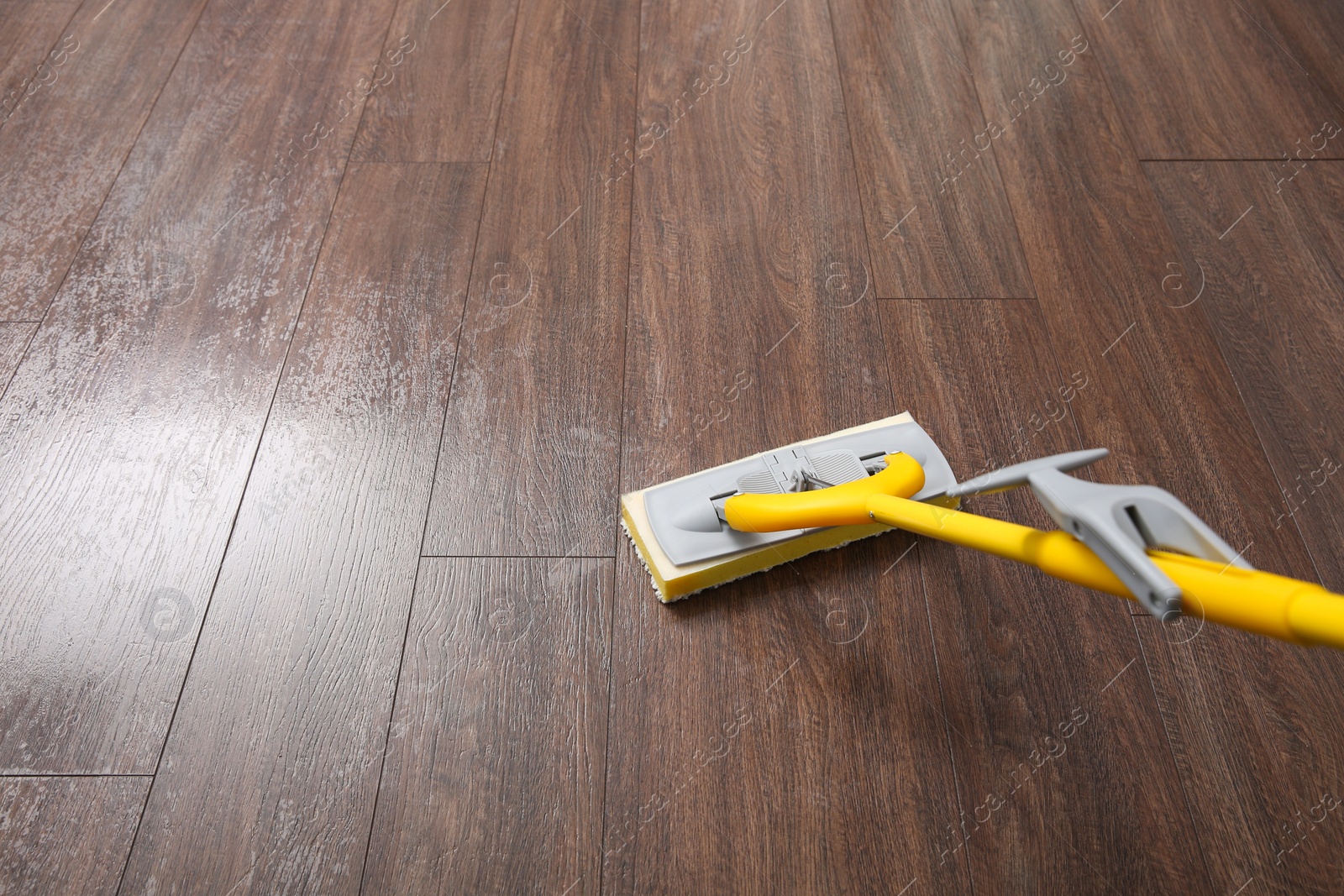 Photo of Washing of parquet floor with mop, closeup. Space for text