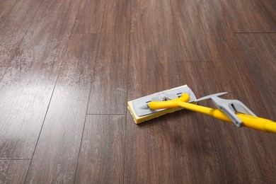 Washing of parquet floor with mop, closeup. Space for text