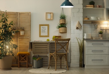 Photo of Modern kitchen interior with wooden crates as eco furniture