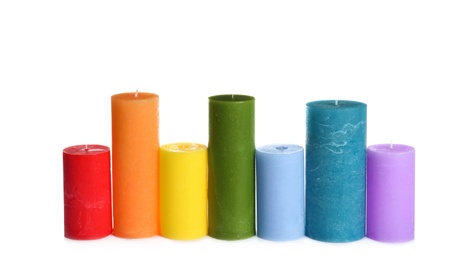 Photo of Different colorful wax candles on white background
