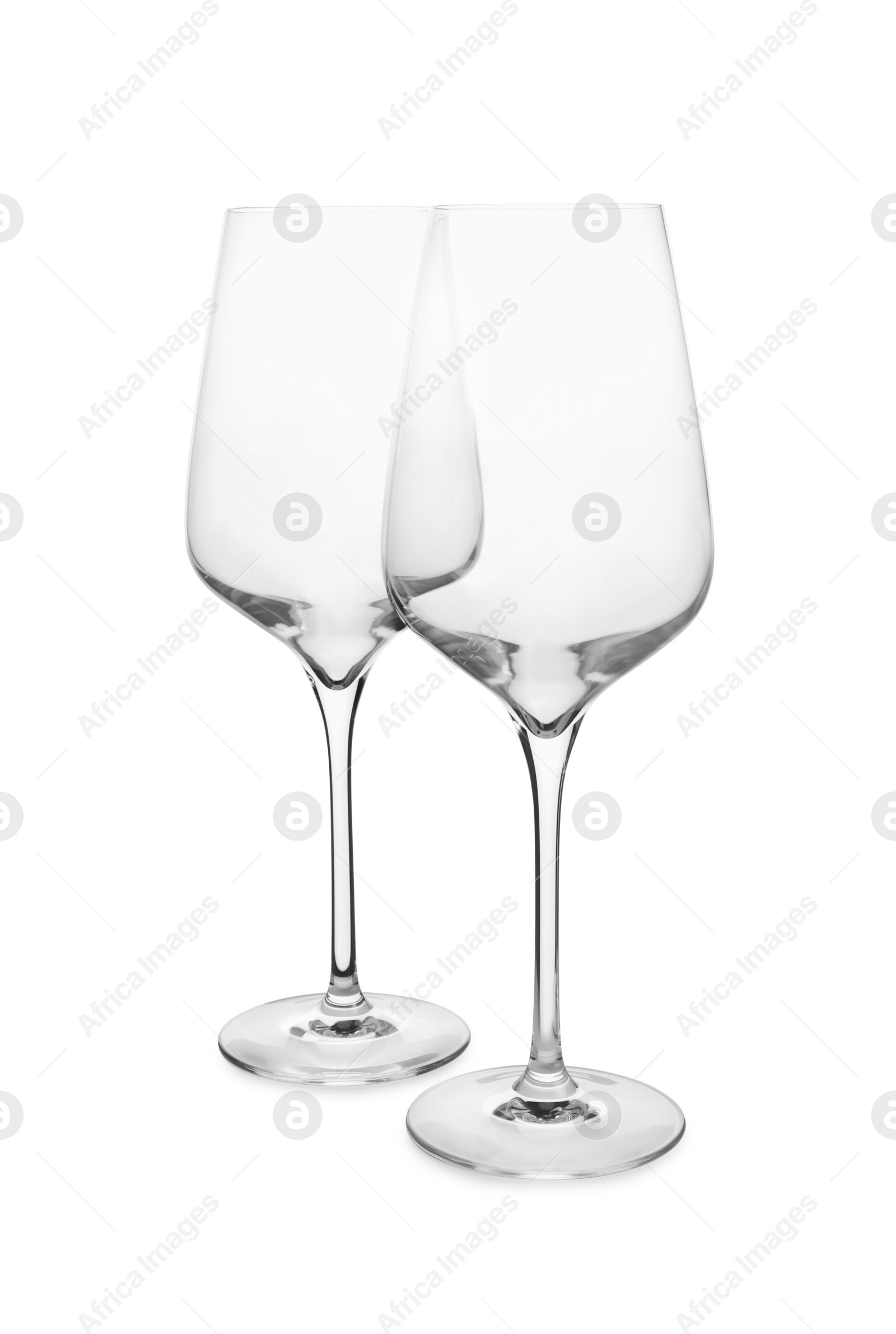 Photo of Elegant clean empty wine glasses isolated on white