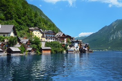 Photo of Picturesque view of small resort town near mountains on riverside