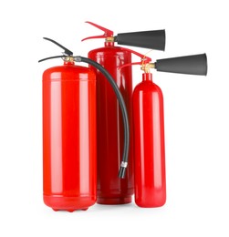 Photo of Three red fire extinguishers on white background