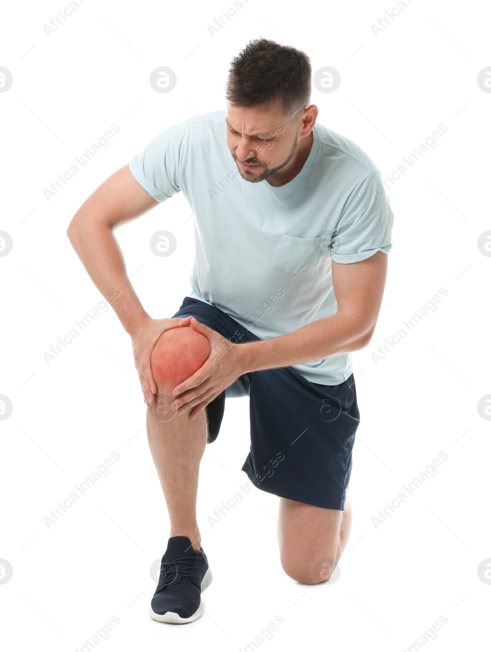 Photo of Full length portrait of sportsman having knee problems on white background