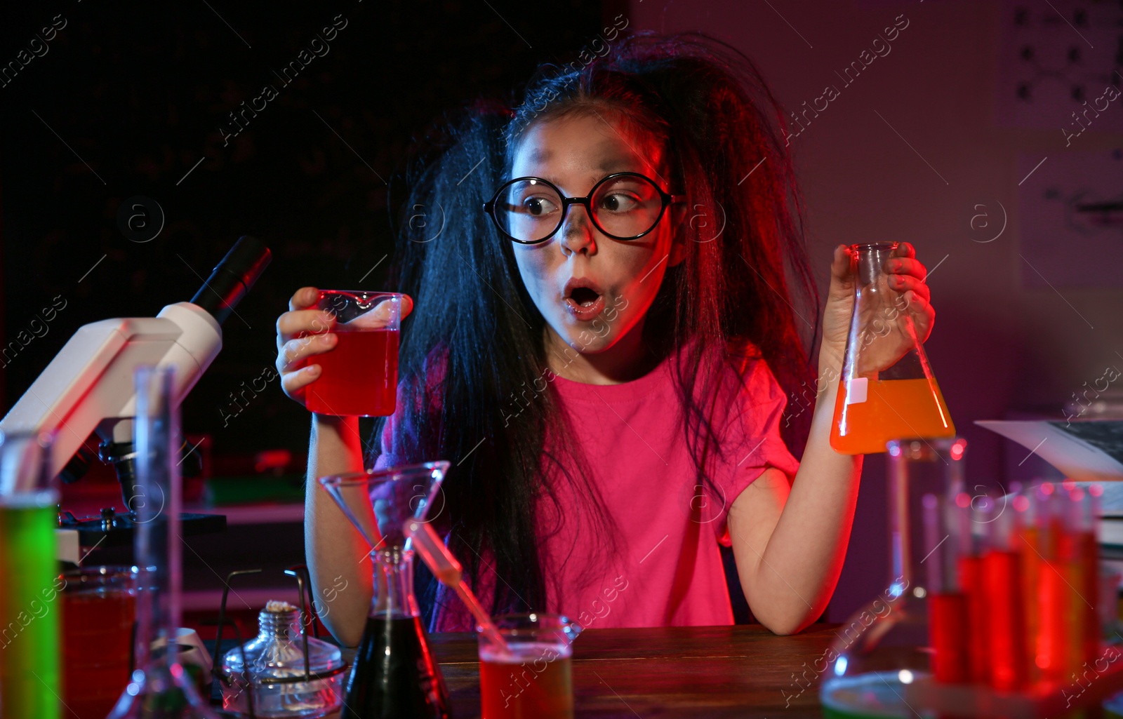 Photo of Child doing chemical research in laboratory. Dangerous experiment