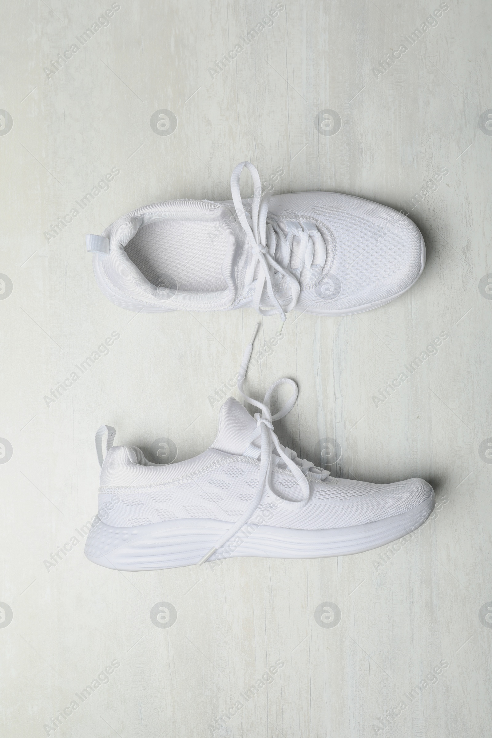Photo of Stylish sport shoes on white background, flat lay. Trendy footwear