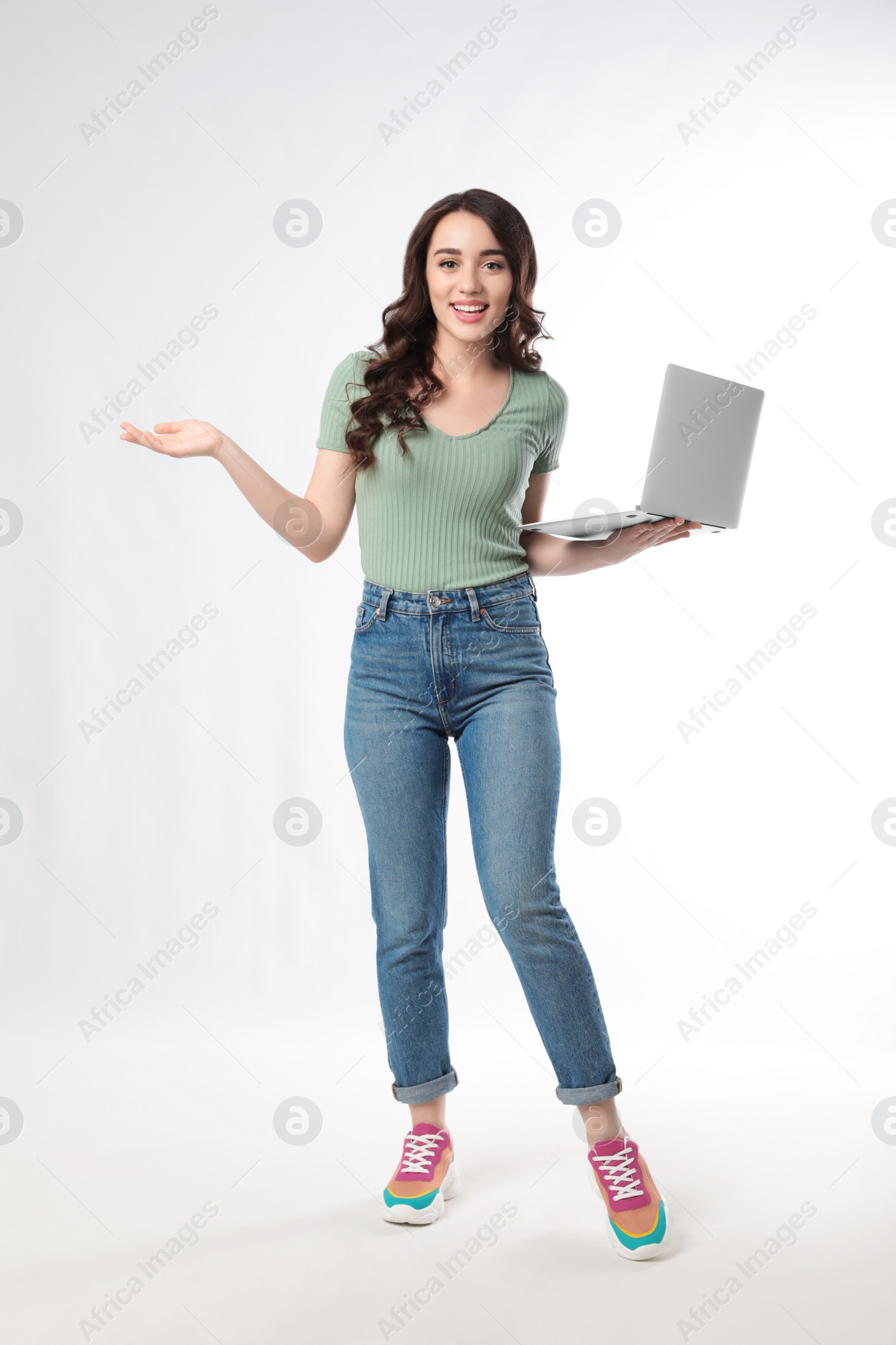 Photo of Young woman with laptop on white background