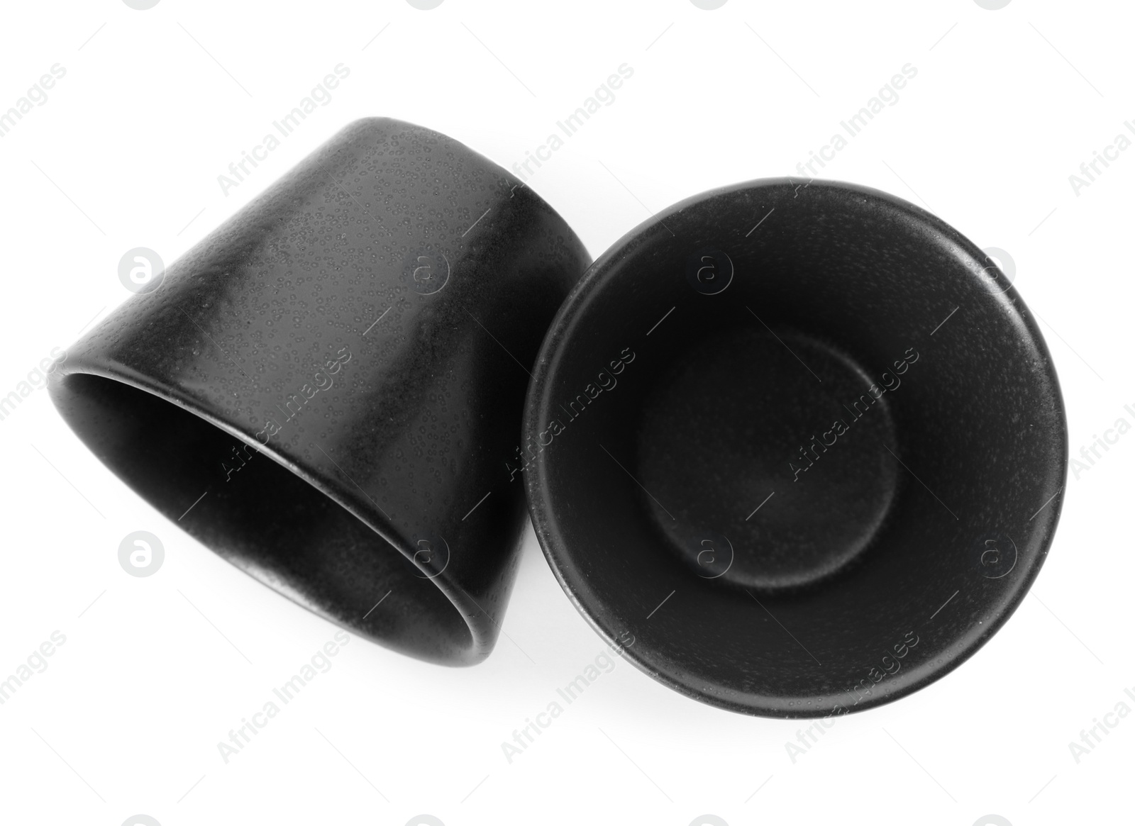 Photo of New black sauce dishes on white background, top view