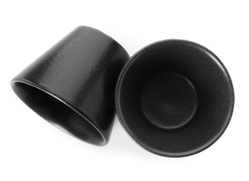 Photo of New black sauce dishes on white background, top view