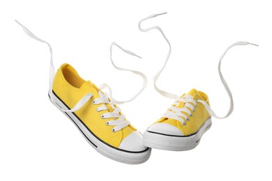 Pair of yellow classic old school sneakers on white background