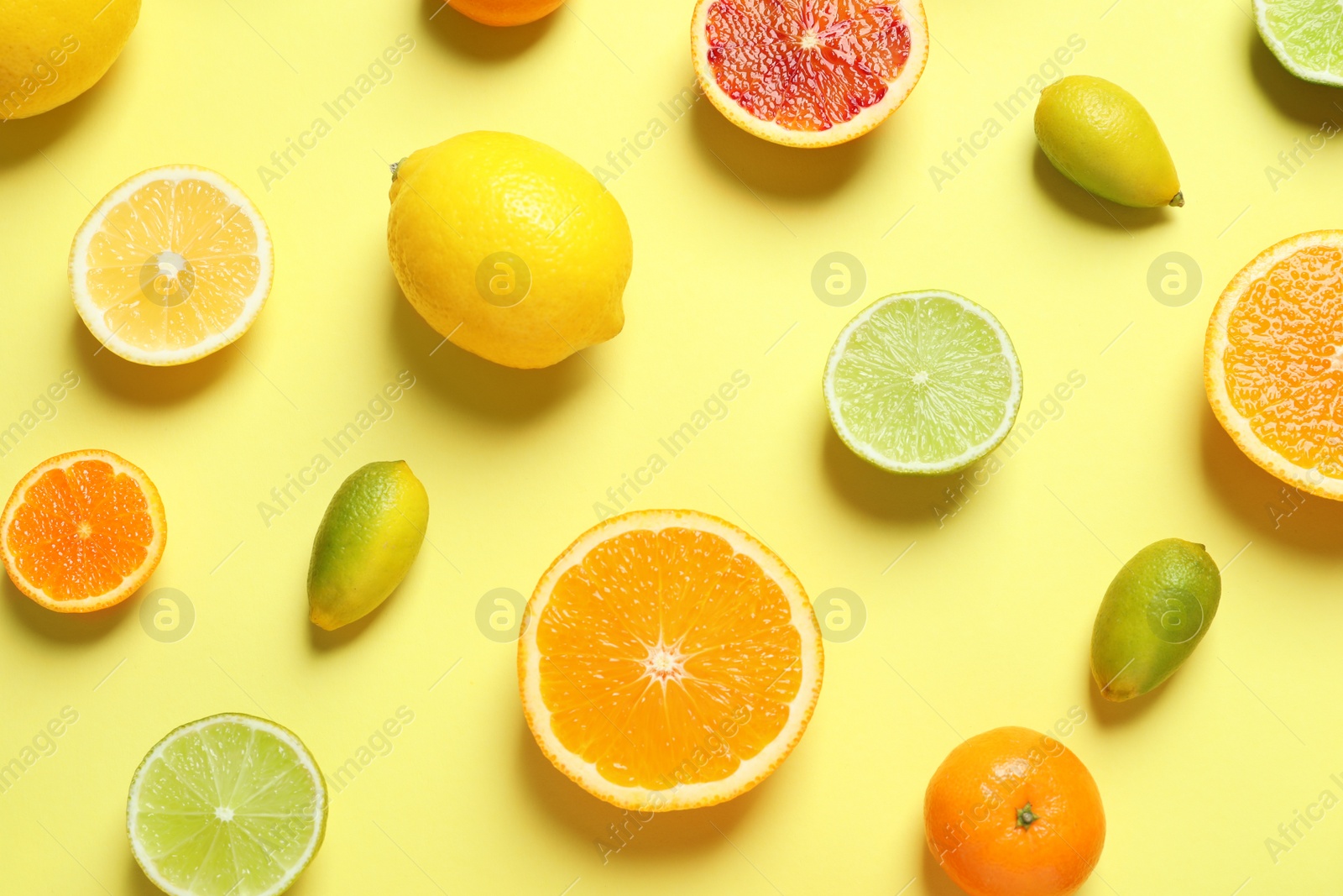 Photo of Different citrus fruits on color background, flat lay