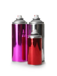 Different cans of spray paints on white background