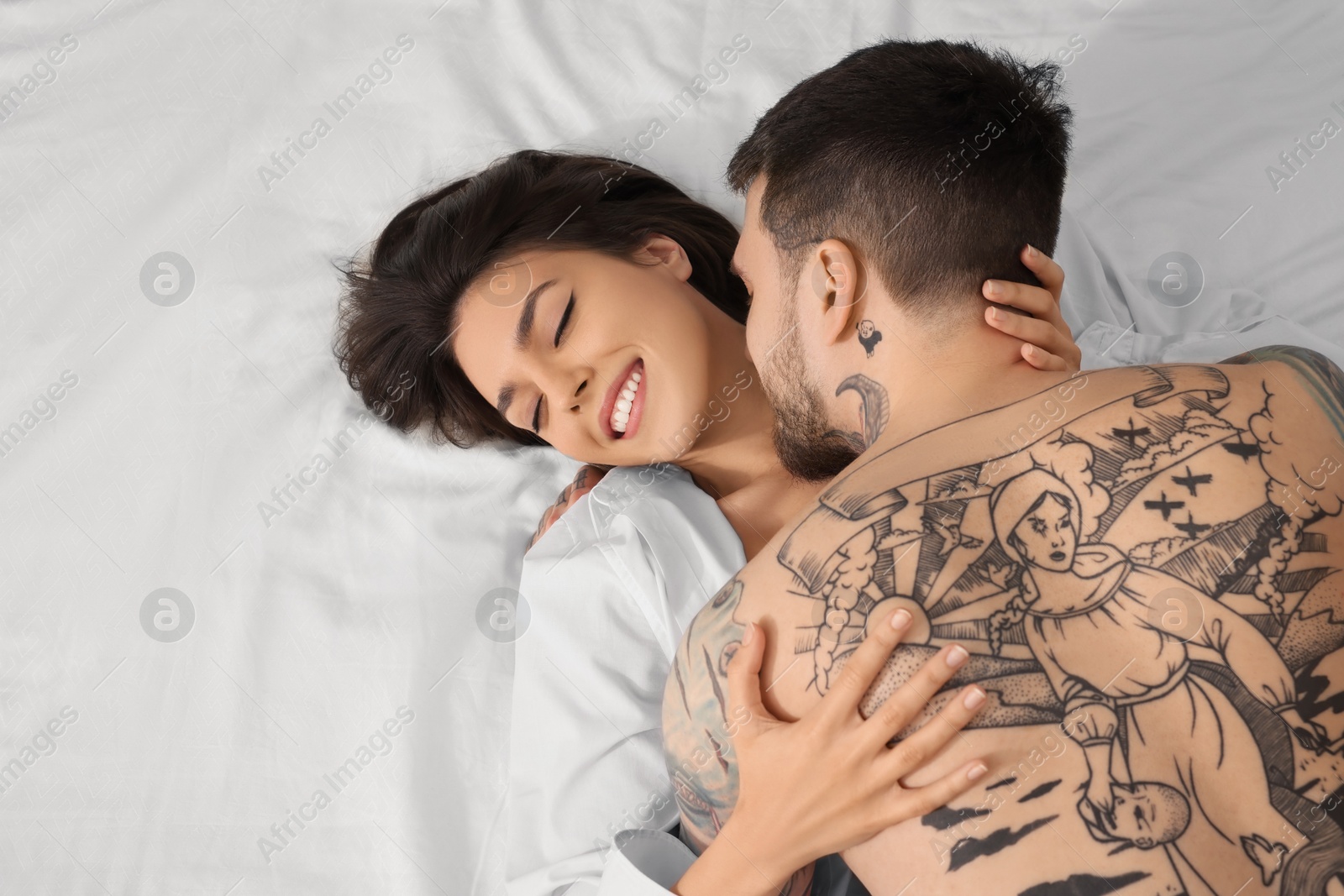 Photo of Passionate couple having sex on bed, top view