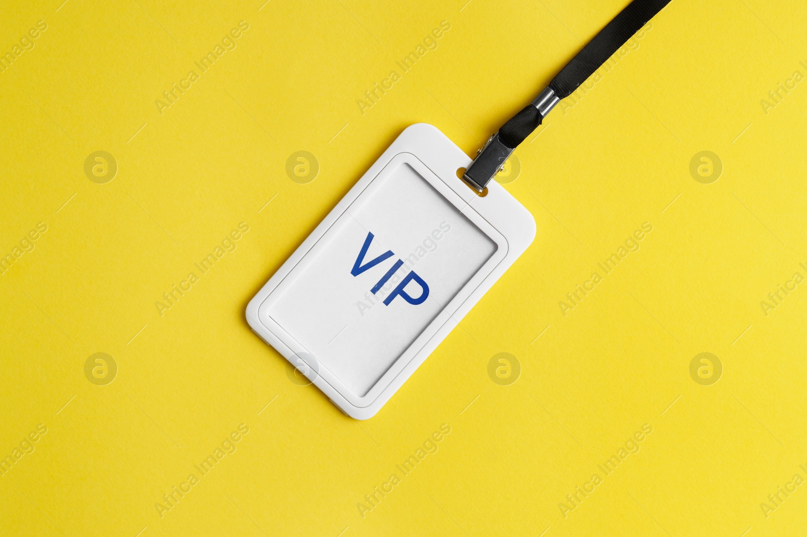 Photo of Vip badge on yellow background, top view