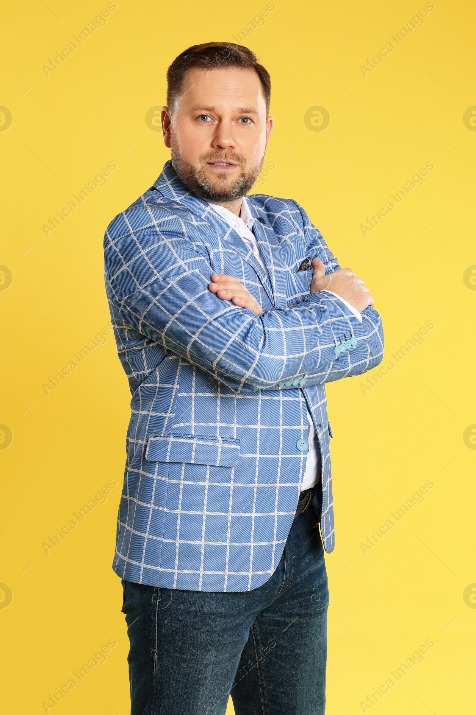 Photo of Portrait of mature man on yellow background