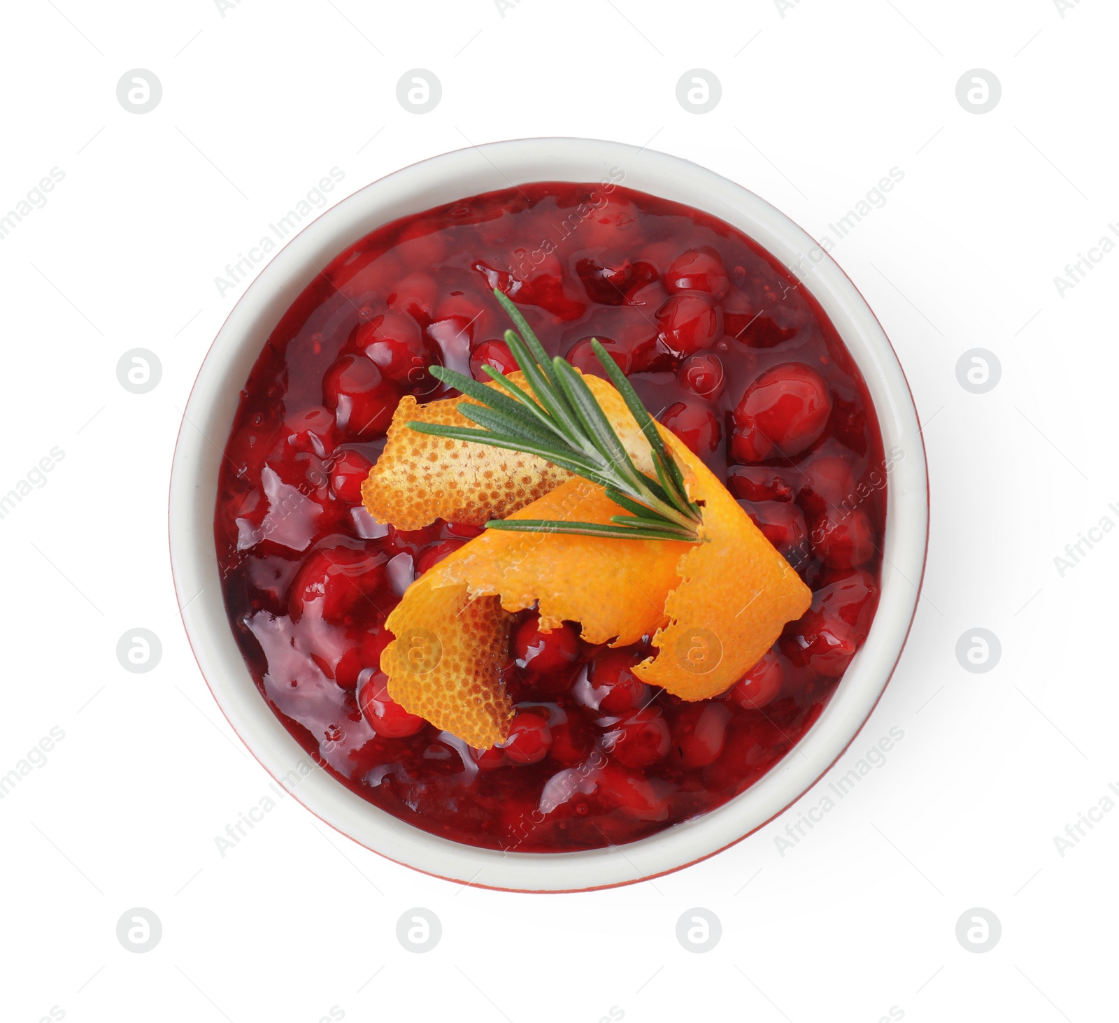 Photo of Fresh cranberry sauce in bowl, rosemary and orange peel isolated on white, top view