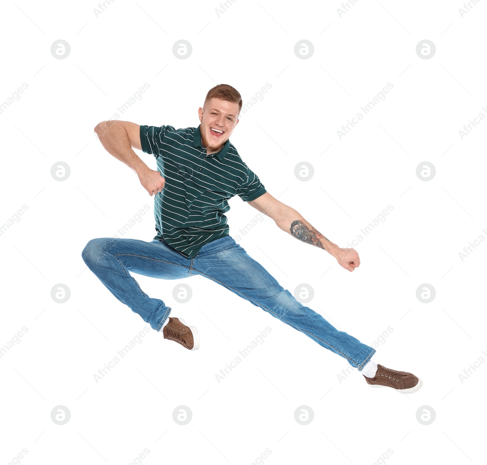 Photo of Handsome young man jumping on white background