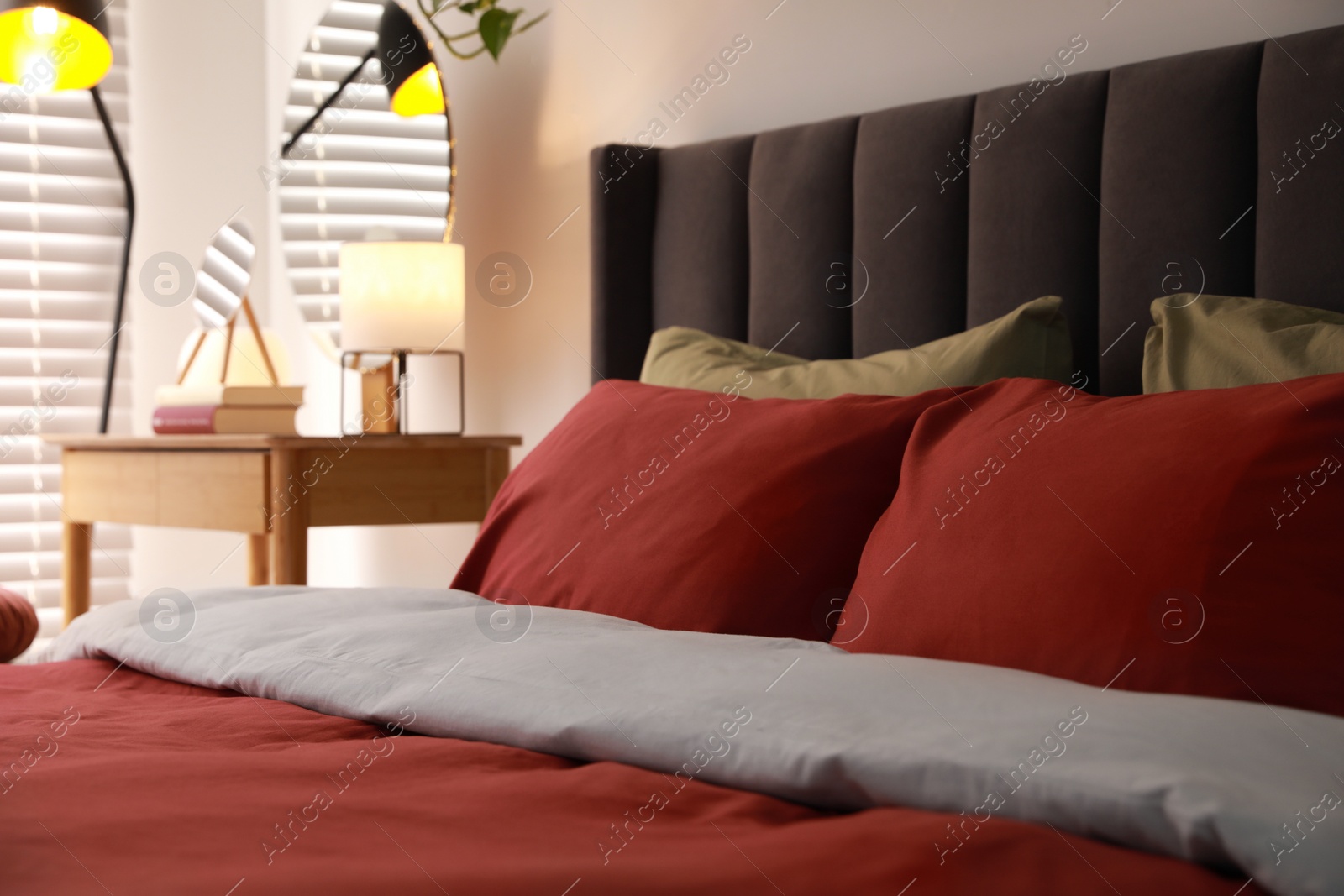 Photo of Comfortable bed with cushions in room. Interior design