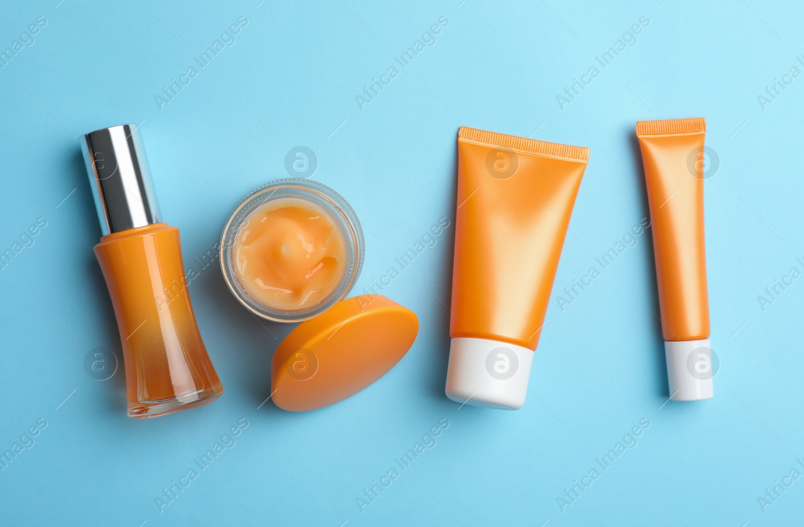 Photo of Set of luxury cosmetic products on light blue background, flat lay