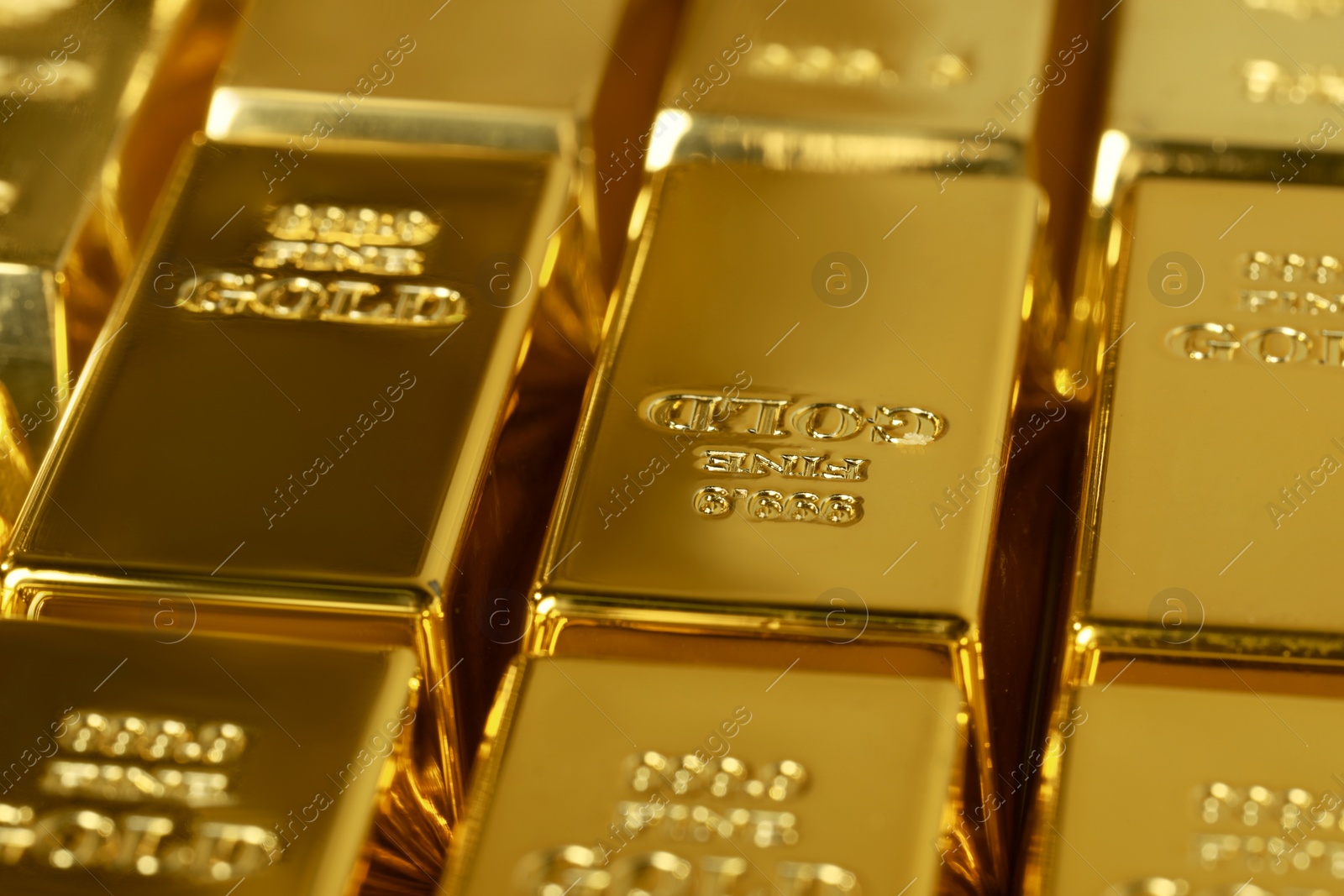 Photo of Many shiny gold bars as background, closeup