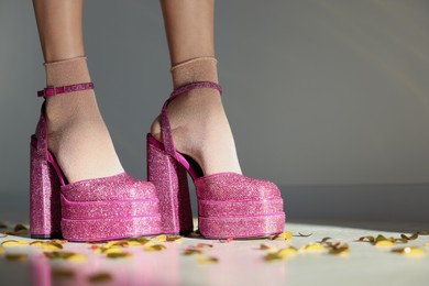 Stylish party. Woman wearing pink high heeled shoes with platform and square toes indoors, closeup. Space for text