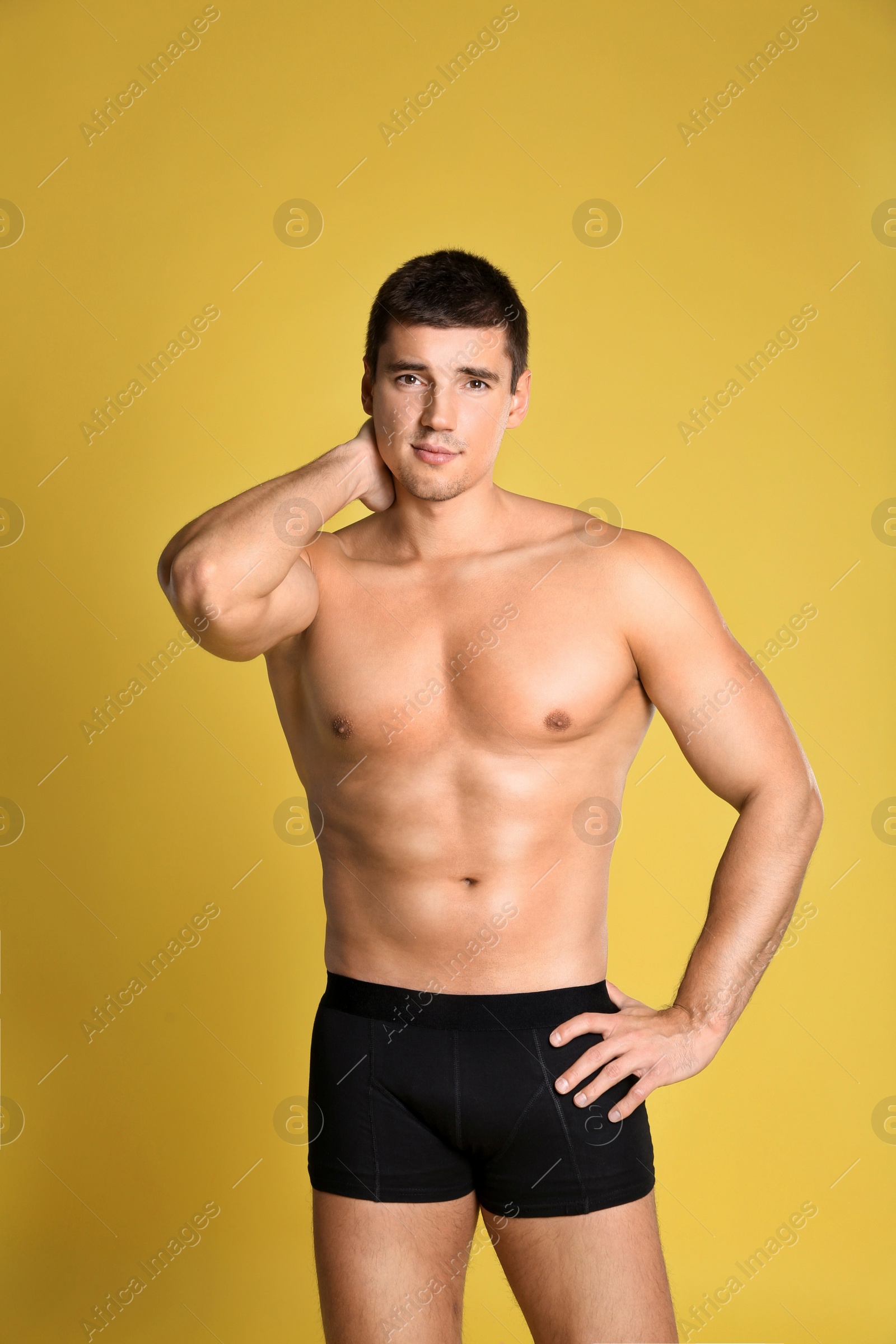 Photo of Man with sexy body on yellow background