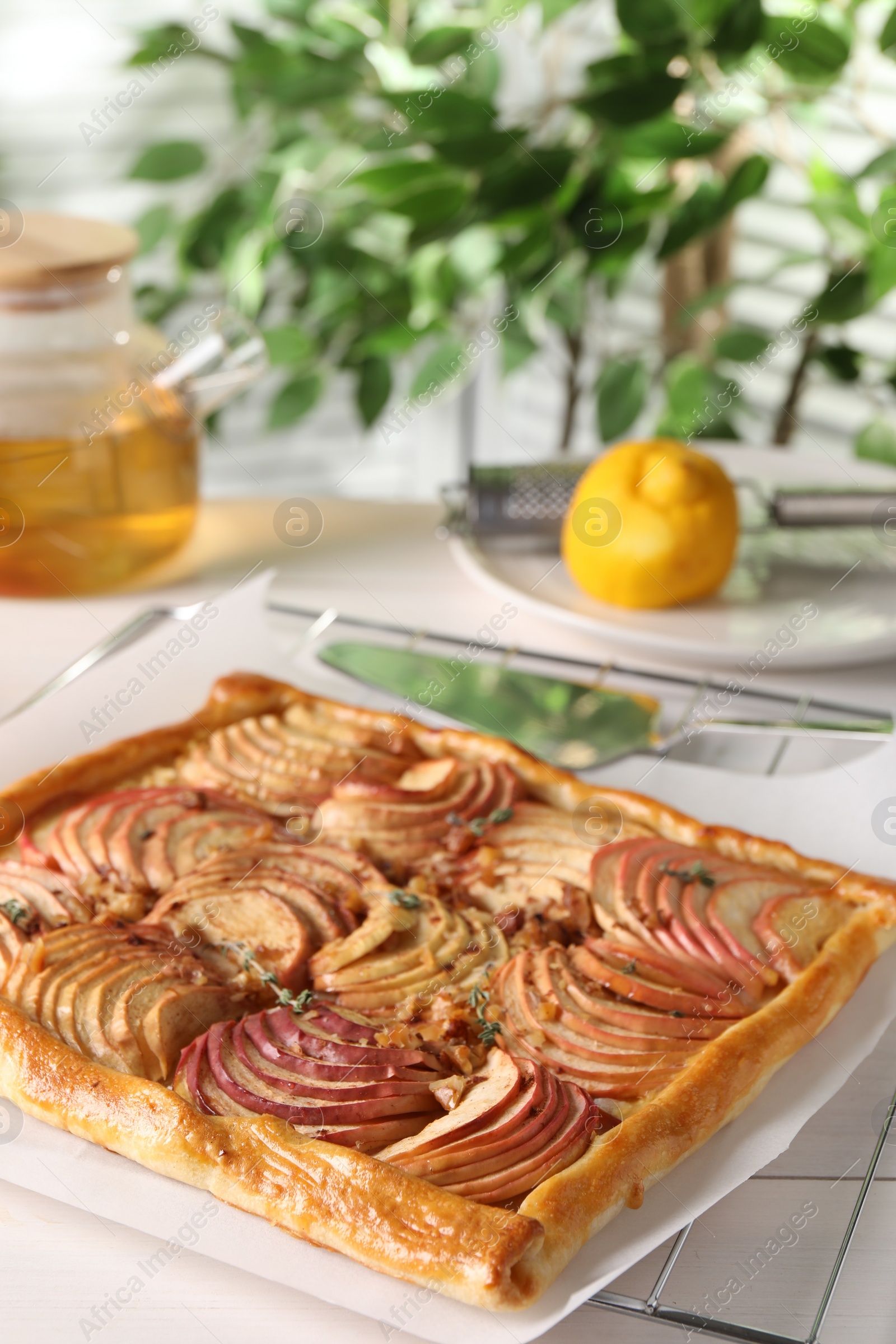 Photo of Freshly baked apple pie on white table