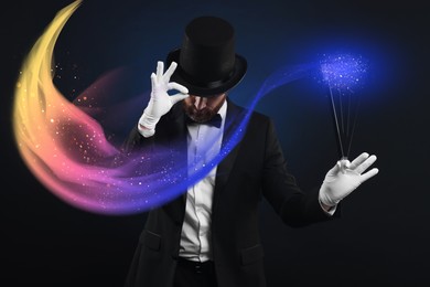 Magic and sorcery. Magician with wand and fantastic light on dark background