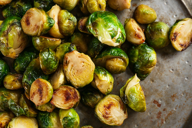 Photo of Delicious roasted Brussels sprouts in frying pan, closeup
