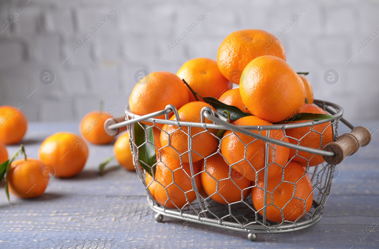 Photo of Fresh ripe tangerines on grey wooden table