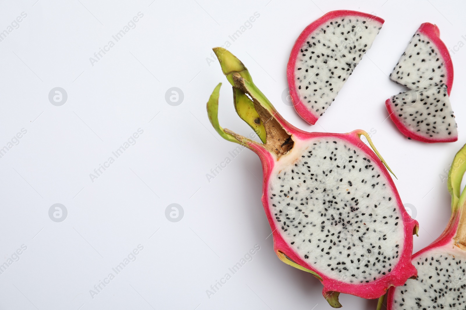 Photo of Delicious cut dragon fruit (pitahaya) on white background, top view